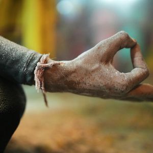 Close-up of hands in a specific yoga mudra gesture.