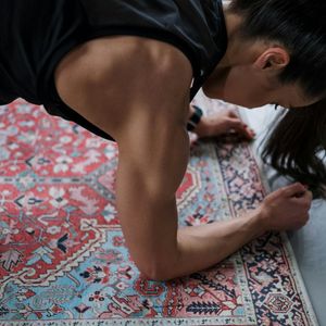 Silhouette showing core strength in a plank variation.